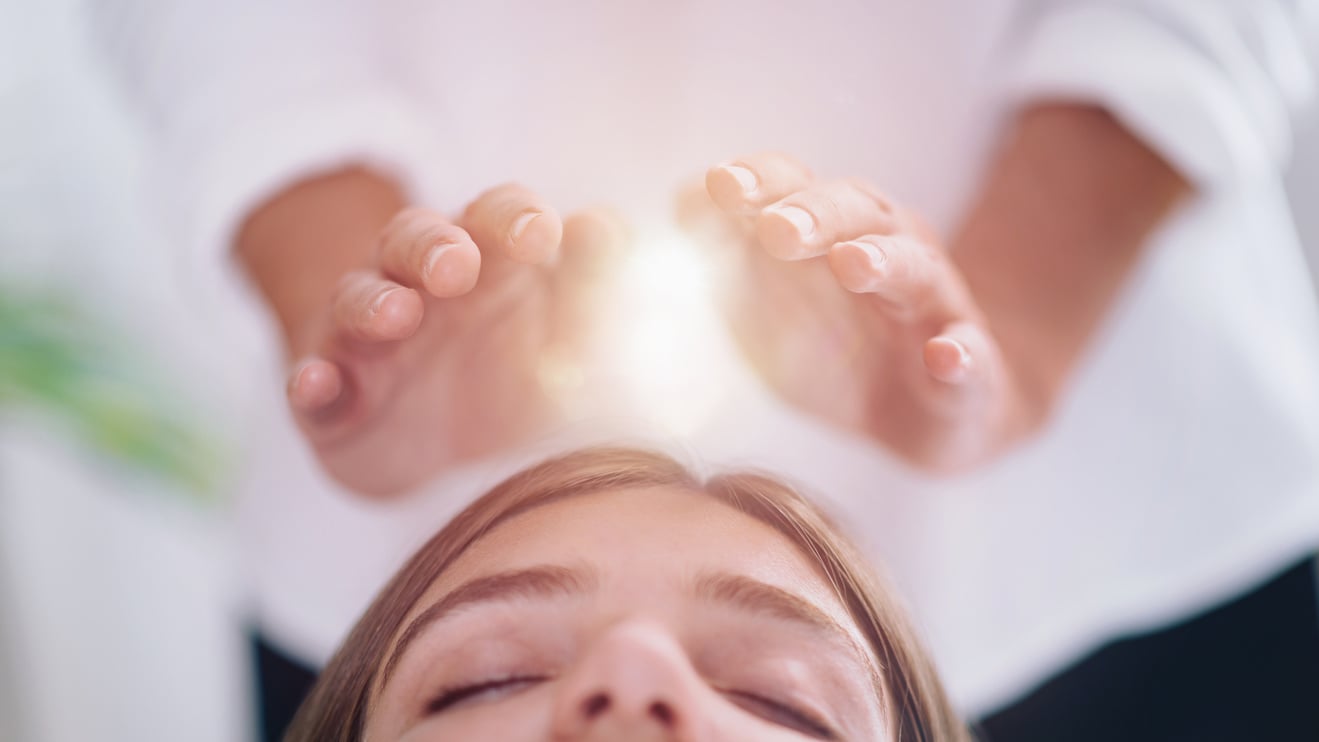 Close Up Of A Relaxed Young Woman Having Reiki Healing Treatment