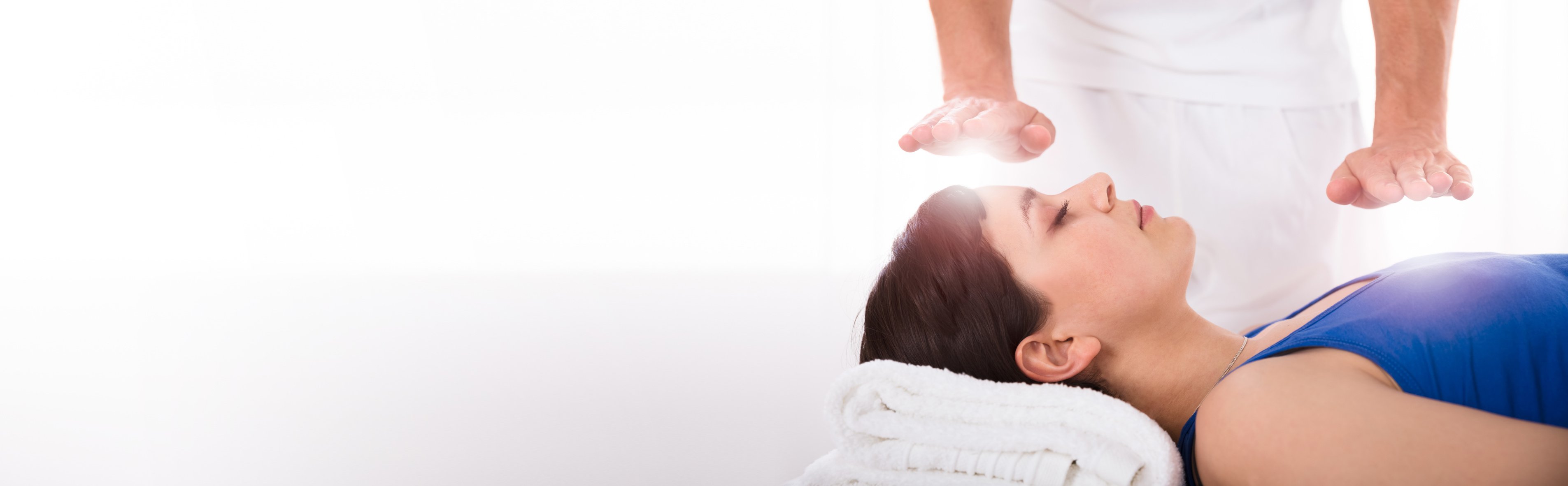 Woman Having Reiki Healing Treatment